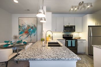 a kitchen with a granite counter top and a sink